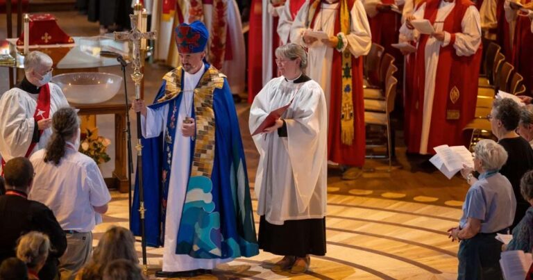 Archbishop Shane Parker bears the primatial cross, primatial mitre and ceremonial garments.